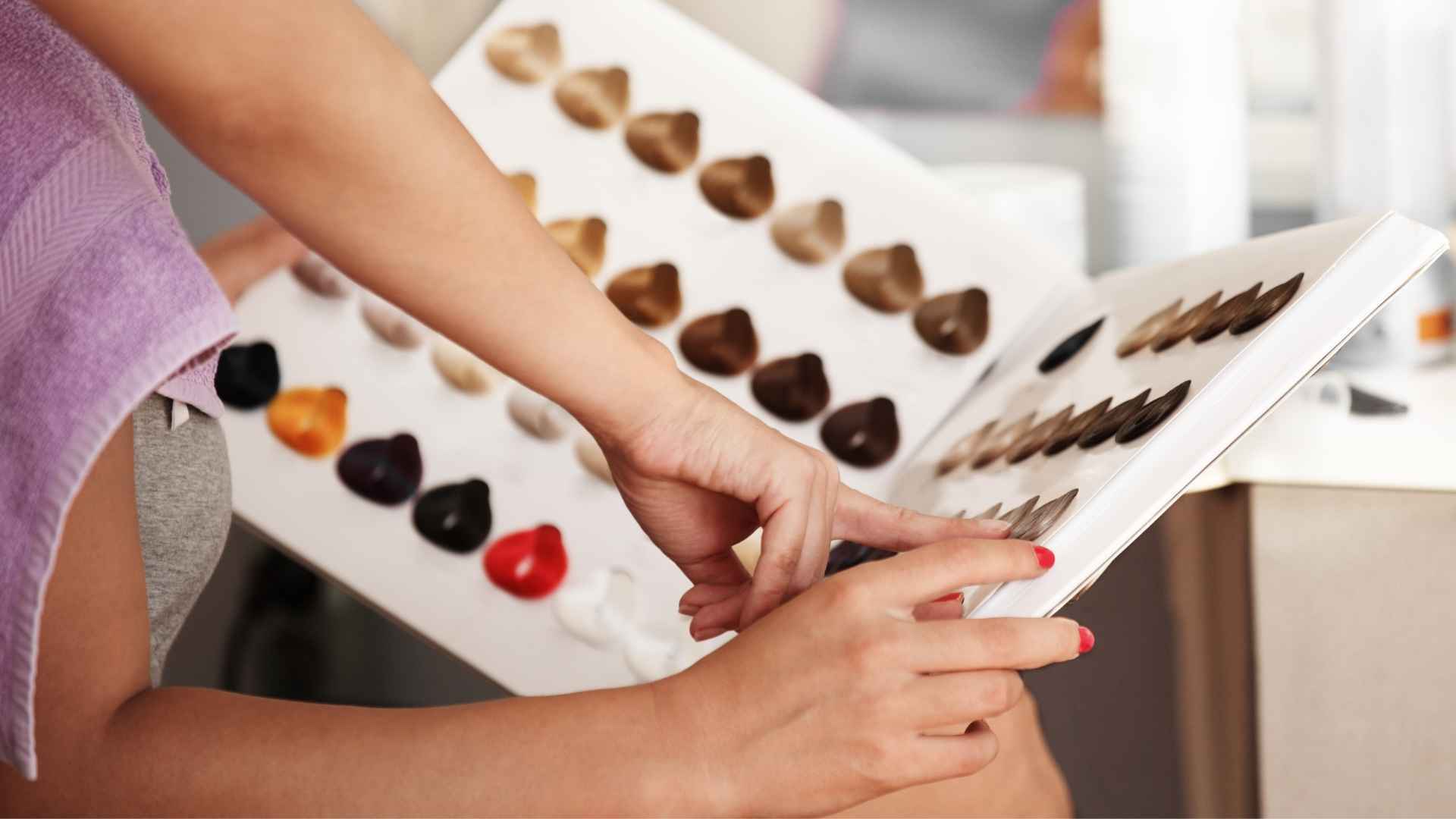 Colorista profissional aplicando técnicas avançadas de coloração de cabelo.